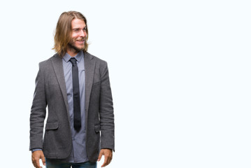 Canvas Print - Young handsome business man with long hair over isolated background looking away to side with smile on face, natural expression. Laughing confident.