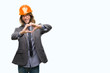 © Krakenimages.com - Young handsome architec man with long hair wearing safety helmet over isolated background smiling in love showing heart symbol and shape with hands. Romantic concept.