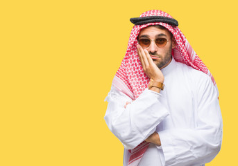 Young handsome man wearing keffiyeh over isolated background thinking looking tired and bored with depression problems with crossed arms.