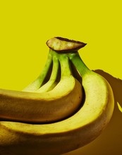 Close Up Of Bananas Against Yellow Background
