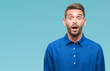© Krakenimages.com - Young handsome man over isolated background afraid and shocked with surprise expression, fear and excited face.