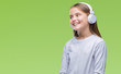© Krakenimages.com - Young beautiful girl wearing headphones listening to music over isolated background looking away to side with smile on face, natural expression. Laughing confident.