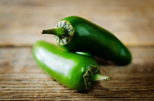 Fresh Jalapeno Peppers On A Dark Wood Background
