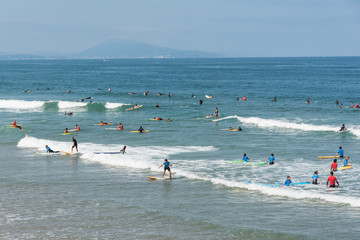 Surfers on the waves of the Atlantic Ocean, France