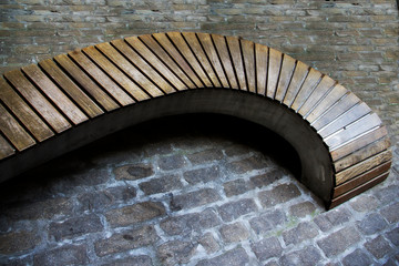 Wall Mural - curved wooden bench in a park