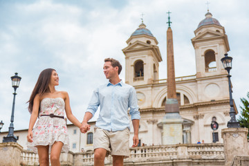 Fototapete - Happy romantic couple holding hands on Spanish Steps in Rome, Italy. Joyful young interracial couple walking on the travel landmark tourist attraction icon during their romance Europe holiday vacation
