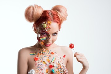 Wall Mural - Girl with sweets on her face isolated shot