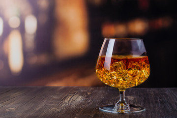 Wall Mural - Glass of Cognac with ice cubes