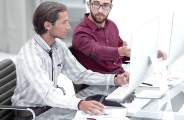 Wall Mural - Two employees , sitting in front of computer