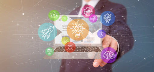 Poster - businessman holding a cloud of colorfull start up icon bubble with a laptop 3d rendering
