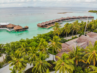 Amazing island in the Maldives ,Beautiful turquoise waters and white sandy beach with  blue sky  background for holiday vacation .