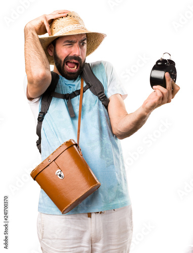 Foto Funny tourist holding vintage clock on isolated white background