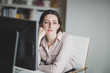 © ReeldealHD images - Thoughtful businesswoman sitting at desk in office