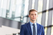 © moodboard - Portrait of confident young businessman standing at office