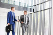 © moodboard - Businessmen discussing while walking at office