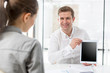 © moodboard - Creative businessman showing digital tablet to colleague in office