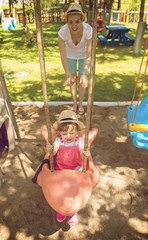 Sticker - mother and daughter swinging in the park