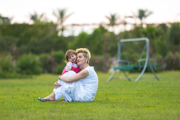 Sticker - mother and little daughter playing at backyard