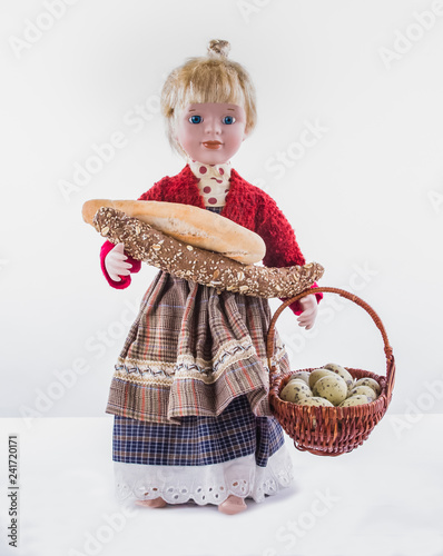 Fotografie, Obraz Girl-Doll toy with bread and basket with quail eggs