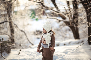 Wall Mural - Children friends play among snowdrifts together.