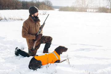 Wall Mural - young gorgeous man and his hunting dog spending time in the fresh air. business. wildlife management.