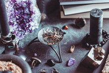 Smoked Herbs On A Witch's Altar For A Magical Ritual Among Crystals And Black Candles.