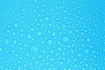 closeup drops water on blue background