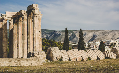 ruins of ancient Greek temple surrounded by mountains and abandoned in park outdoor environment