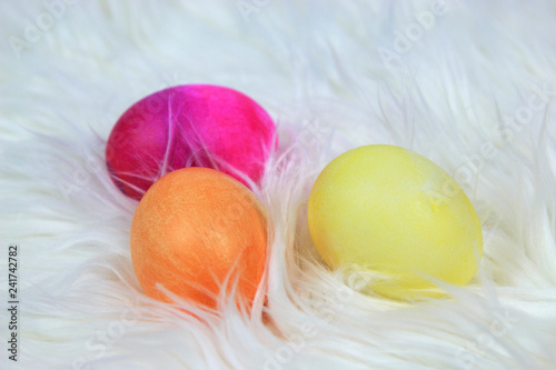 Fotografie, Obraz Colorful dyed Easter Eggs laying on white Soft Fur