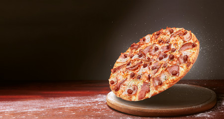 Wall Mural - classic pizza on a dark wooden table background and a scattering of flour. pizza restaurant menu concept