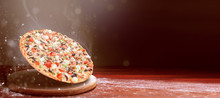Classic Pizza On A Dark Wooden Table Background And A Scattering Of Flour. Pizza Restaurant Menu Concept