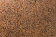 Textured Background Surface Of Textile Upholstery Furniture Close-up. Leatherette Brown Color Fabric Structure