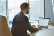 © Artem - The businessman in glasses working with a laptop