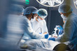 © alfa27 - Blurred shot of group of professional surgeons at work in operating room. Emergency case, surgery, medical technology, health care cancer and disease treatment concept