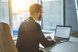© Artem - The businessman sitting at the table with a modern laptop