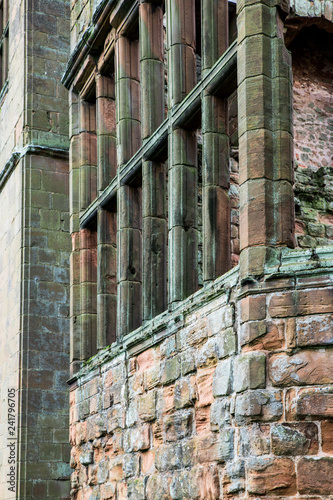Fotografie, Obraz Detail of Window and rough stone exterior wall on ancient medieval structure