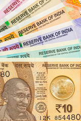 Close up view of brand new indian 10, 50, 100, 200, 500 and 2000 rupees banknotes and coin.