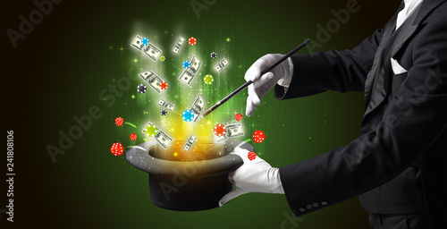 фотография Illusionist conjure with magic wand gambling things from a cylinder