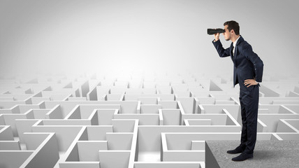 Wall Mural - businessman standing on maze and looking forward to the future concept