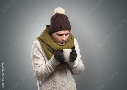 Fotografía Handsome young boy freezing in warm clothing with copy space
