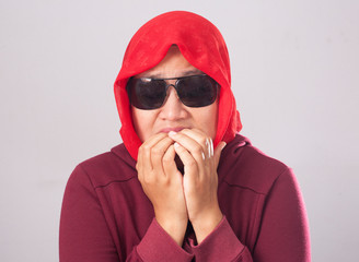 Wall Mural - Worried Muslim Lady in Red Biting Nails