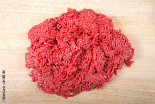 Fotografie, Obraz Close up of raw ground hamburger meat low fat, on a light wood cutting table