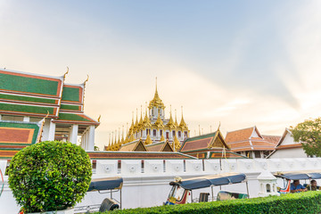 Loha Prasart metal buddhist temple golden pagoda sunset sky with cloud