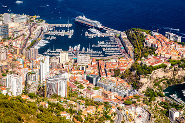 Aerial view of Kingdom of Monaco, view from La Turbie, landmark of Monaco, Monte-Carlo, port Hercules, port Fontvieille, Monaco Ville, Palace of Prince, orange color of roofs, Cruise liner, blue sea