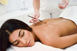 © javiindy - Woman receiving back massage treatment with oil brush in spa wellness center