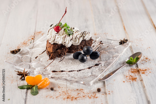 Fotografie, Obraz Sweet creamy cake with fruits on the white wooden background