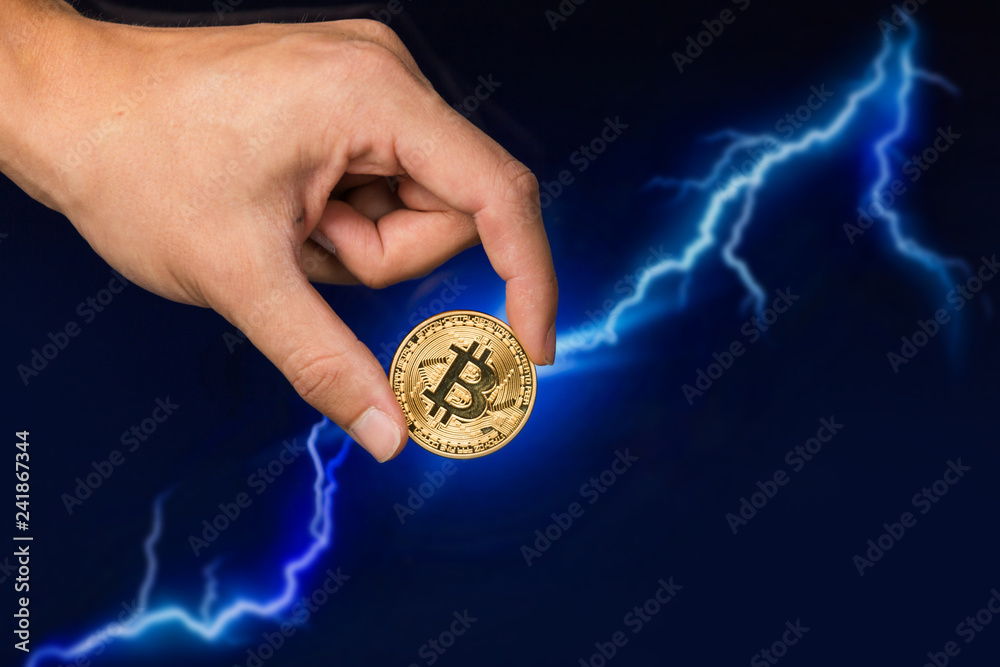 Man holding Bitcoin gold coin in front of lightning network concept background