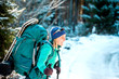 © zhukovvvlad - Woman with backpack and snowshoes in the winter mountains.