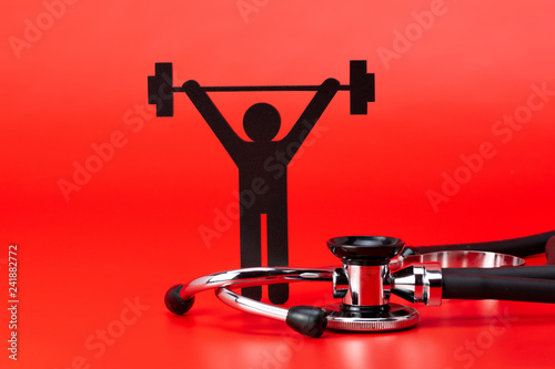 Fotografía Weight lifting pictogram, Stethoscope, close-up isolated