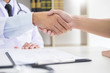 © snowing12 - doctor at the clinic giving an handshake to his patient for encouragement and empathy, healthcare and assistance concept.